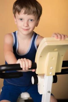The child is trained on a stationary bike . Healthy lifestyle. Stock Photos