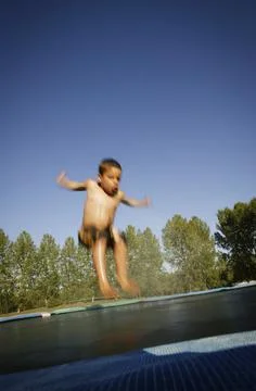 Child On The Trampoline Stock Photos