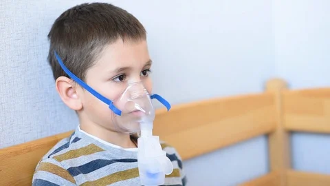 The child is treated with a nebulizer from COVID-19. Stock Footage 128254063