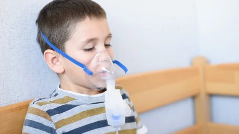 The child is treated with a nebulizer from COVID-19. Stock Footage 128254433