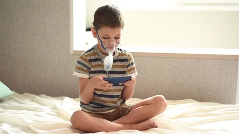 The child is treated with a nebulizer from COVID-19. Stock Footage 128918332