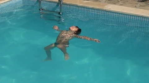 Child tries to float on his back but fails Stock Footage 121825434