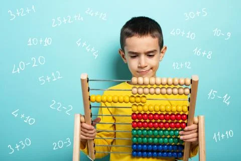 Child tries to solve mathematical problem with abacus. Cyan background Stock Photos