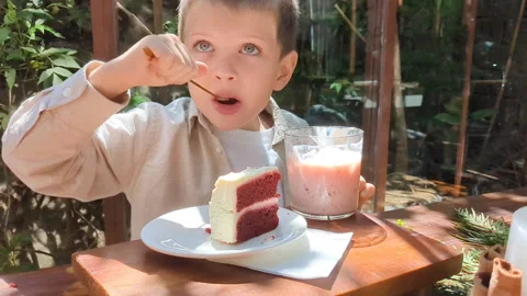 Child trying cake by spoon. Stock Footage 273044148