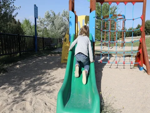 Child trying to climb slide from back Stock Footage 76782632