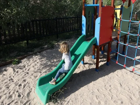 Child trying to climb slide from side Stock Footage 76782983
