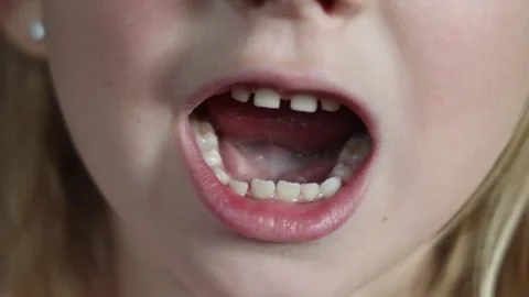Child is trying to get rid of a missing tooth. Stock Footage 255411548
