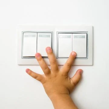 Child turns off the light Stock Photos