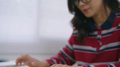 Child typing on wireless keyboard in cozy indoor setting with natural light.. Stock Footage 344917853
