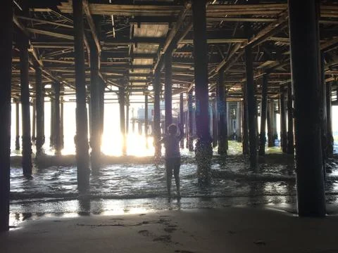 Child under the pier Stock Photos