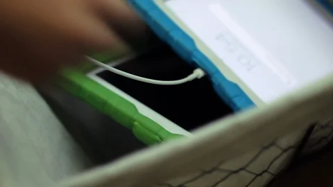 Child unplugging ipad Video stock 95999614