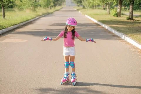 The child unsuccessfully learns to rollerblade Stock Photos