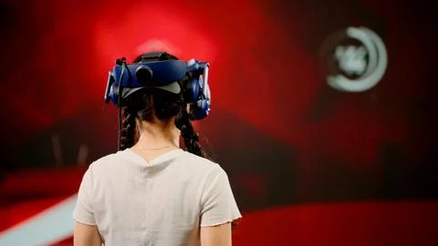 The child use tracking controllers in her hands, moves actively immersing Stock Photos