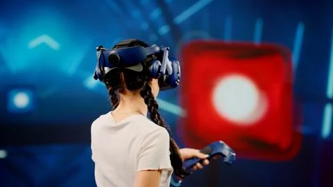 The child use tracking controllers in her hands, moves actively immersing Stock Photos