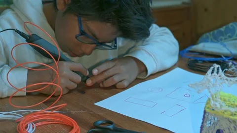 A child uses the 3d pen Stock Footage 219771996