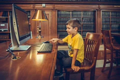 Child uses computer in the suggestive New York Public Library Stock Photos