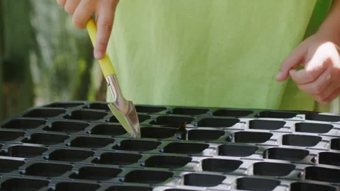 The child uses a garden tool Stock Footage 196575887
