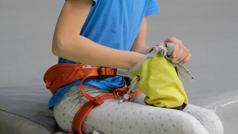 A child uses magnesia to train at a climbing wall Stock Footage 116892236