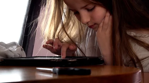 Child uses a tablet Stock Footage 97448086