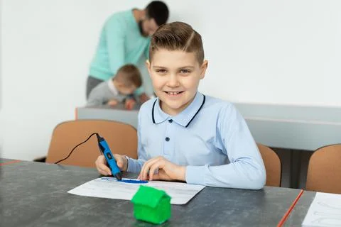 Child using 3D printing pen. Boy making new item. Creative, technology, leisure Foto stock