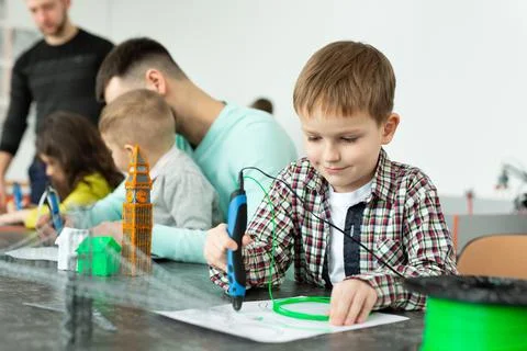 Child using 3D printing pen. Boy making new item. Creative, technology, leisure Foto stock