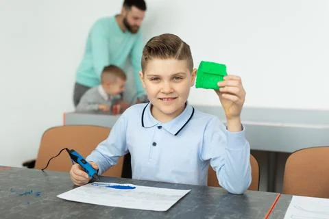 Child using 3D printing pen. Boy making new item. Creative, technology, leisure Foto stock