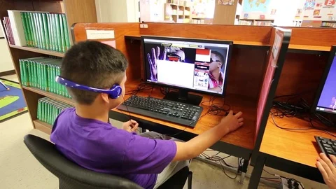 Child using computer at South Texas Residential Family Detention Centre Stock Footage 93544641