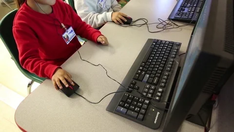 Child using computer at South Texas Residential Family Detention Centre Stock Footage 93544672