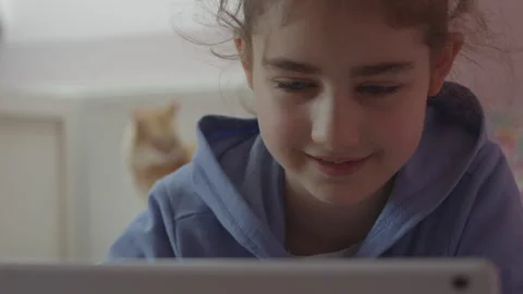 Child Using Digital Tablet Browsing Internet Chat At Home. Stock Footage 294973774