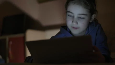 Child Using Digital Tablet Evening at Home. Teen Girl Watching Online Video.. Stock Footage 329447102