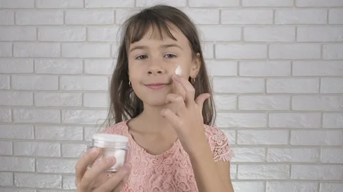 Child using face cream. Stock Footage 101515139