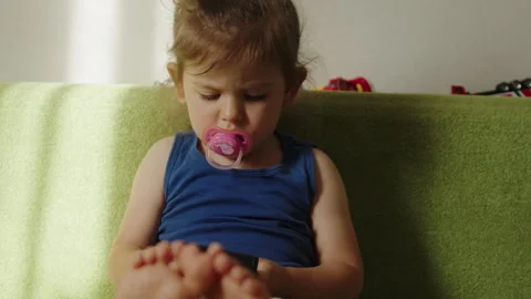 Child using a game device to learn and play games, model is young girl. Happy Stock Footage 258852052
