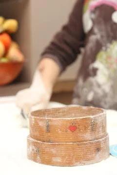 Child using hand tools to create art in bright kitchen Stock Photos