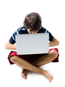 Child using laptop computer on the floor Stock Photos