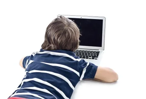 Child using laptop computer on the floor Stock Photos
