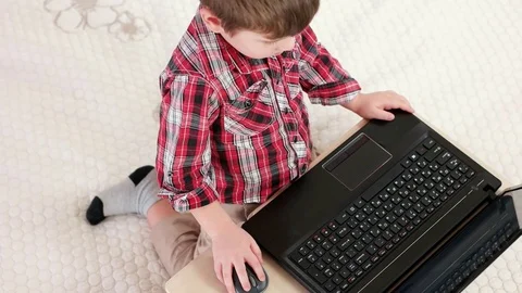 child using laptop computer at home, lit... | Stock Video | Pond5