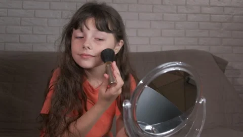 Child using makeup brush by mirror. Stock Footage 265192353