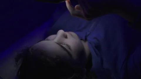 Child Using Mobile Phone Evening at Home. Teen Girl Watching Online Video S.. Stock Footage 329447982