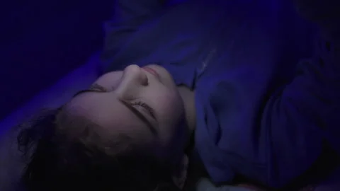 Child Using Mobile Phone Evening at Home. Teen Girl Watching Online Video S.. Stock Footage 329448460