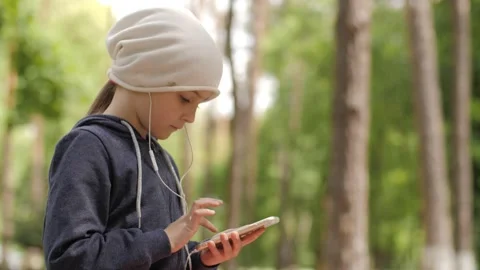 Child is using mobile phone. Kid is looking at screen of devices. Video stock 131771849