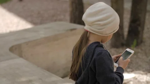 Child is using mobile phone. Kid is looking at screen of devices. Stock-Footage 131771950