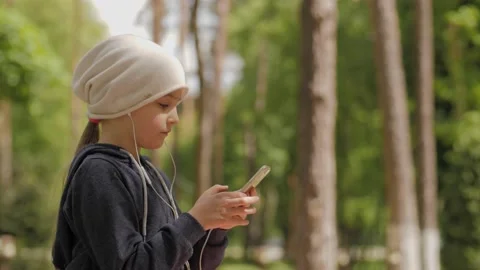 Child is using mobile phone. Kid is looking at screen of devices. Stock-Footage 131772357