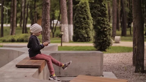 Child is using mobile phone. Kid is looking at screen of devices. Stock-Footage 131773032