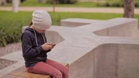Child is using mobile phone. Kid is looking at screen of devices. Stock-Footage 131773152