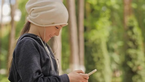 Child is using mobile phone. Kid is looking at screen of devices. Stock-Footage 132998786