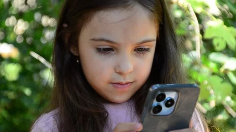 Child is using mobile phone. Kid is looking at screen of devices Video stock 282860842
