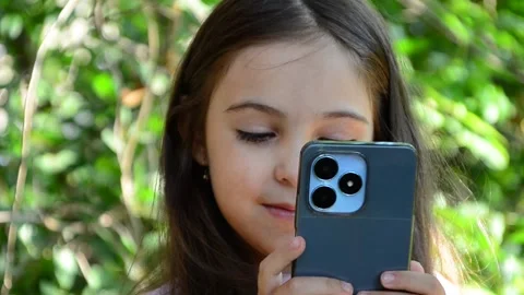 Child is using mobile phone. Kid is looking at screen of devices Video stock 282860856