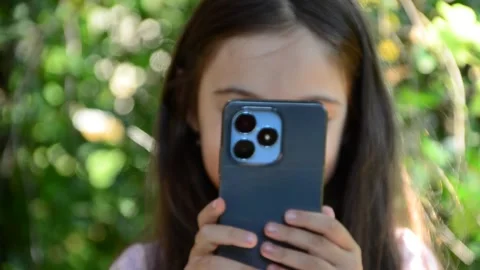 Child is using mobile phone. Kid is looking at screen of devices Video stock 282860860