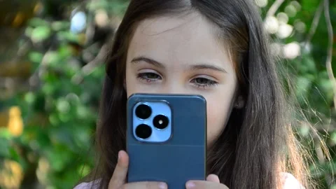 Child is using mobile phone. Kid is looking at screen of devices Video stock 282860867