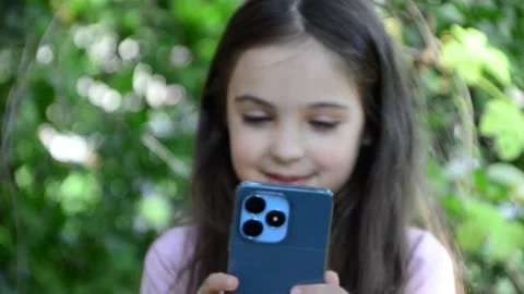 Child is using mobile phone. Kid is looking at screen of devices Video stock 282860869